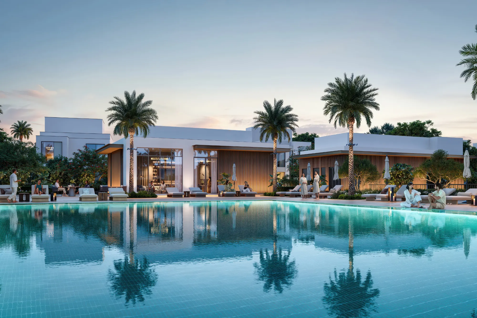 Community pool with sun loungers in front of the clubhouse at dusk