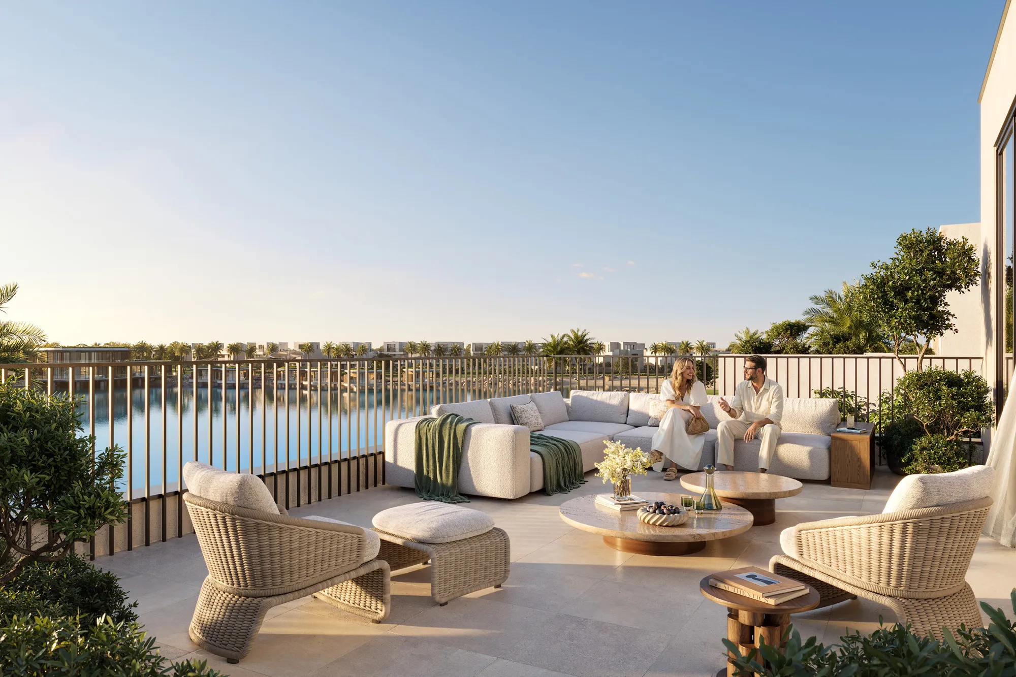 Roof terrace with sofas and woven chairs overlooking the lake